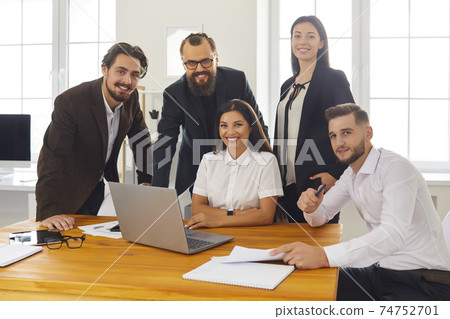 Group portrait of happy smiling business people near laptop in business center office. Group portrait of happy smiling business people near laptop in business center office. 74752701