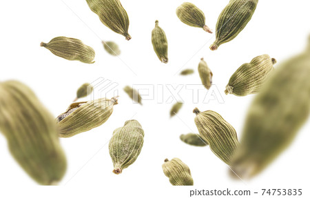 Cardamom pods levitate on a white background Cardamom pods levitate on a white background 74753835