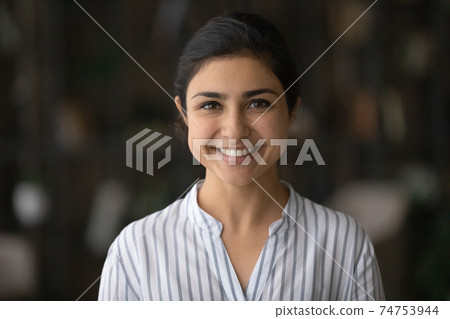 Headshot portrait of smiling Indian millennial woman Headshot portrait of smiling Indian millennial woman 74753944