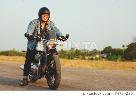 Young man riding big bike motocycle on asphalt high way against, Motorbike man has freedom 74754286