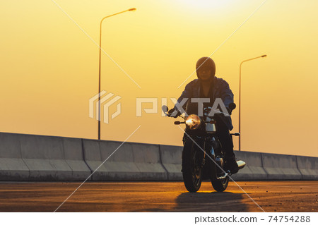 Young man riding big bike motocycle on asphalt high way against, Motorbike man has freedom 74754288