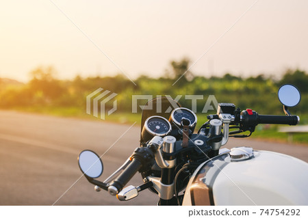 Hands of motorcyclist on a street Alpine highway 74754292