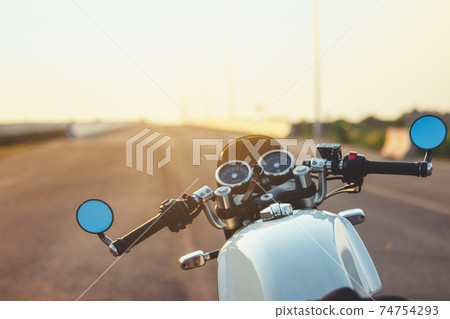Hands of motorcyclist on a street Alpine highway 74754293