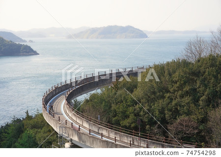 People who enjoy cycling in the beautiful Seto Inland Sea National cycle route "Shimanami Kaido Cycling Road" 74754298
