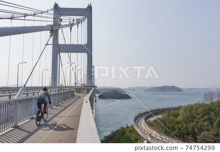 People who enjoy cycling in the beautiful Seto Inland Sea National cycle route "Shimanami Kaido Cycling Road" People who enjoy cycling in the beautiful Seto Inland Sea National cycle route "Shimanami Kaido Cycling Road" 74754299