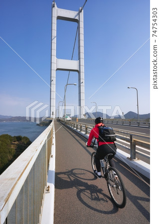 People who enjoy cycling in the beautiful Seto Inland Sea National cycle route "Shimanami Kaido Cycling Road" 74754303