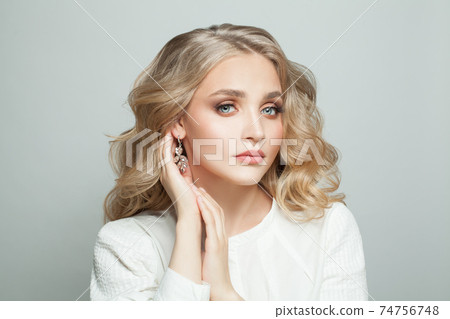 Young blonde woman with long perfect hair on white background Young blonde woman with long perfect hair on white background 74756748