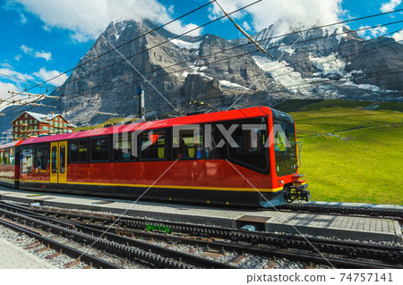 Modern tourist train in the empty train station, Grindelwald, Switzerland Modern tourist train in the empty train station, Grindelwald, Switzerland 74757141