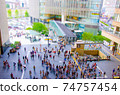 A miniature landscape of a concourse where people are constantly coming and going 74757454