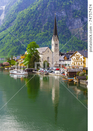 emerald lake and beautiful village Halstatt in Austrian Alps 74757474