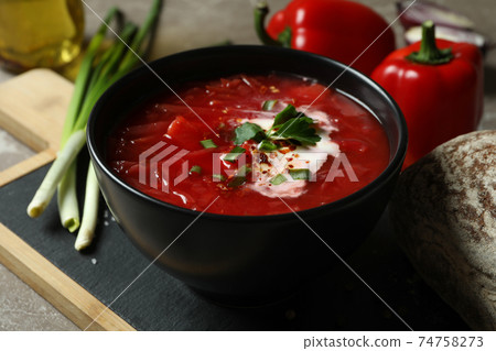 Concept of tasty eating with borscht on gray background Concept of tasty eating with borscht on gray background 74758273