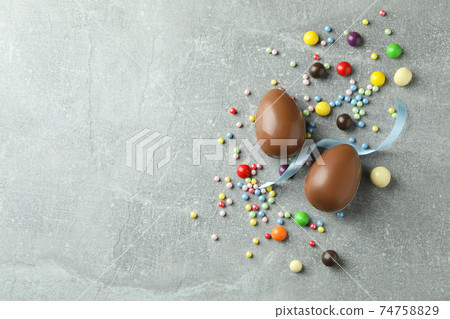 Easter chocolate eggs and candies on gray background 74758829