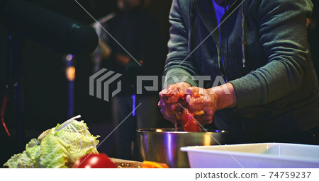 Crop sound designer squeezing vegetables over bowl Crop sound designer squeezing vegetables over bowl 74759237