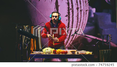 Man creating pottery sounds with vegetables 74759245