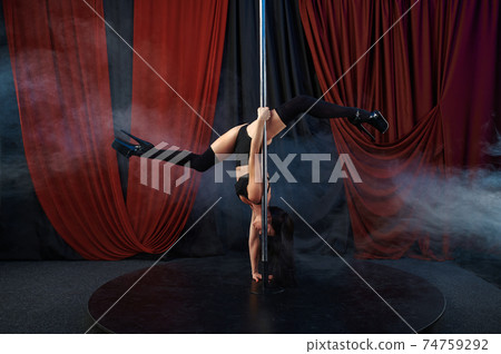 Showgirl in black lingerie, pole dance, striptease Showgirl in black lingerie, pole dance, striptease 74759292