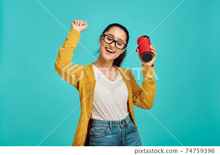 Young woman listens to music, positive emotion Young woman listens to music, positive emotion 74759396