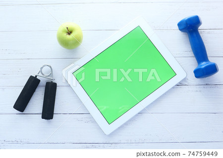 digital tablet with sports equipment on black background digital tablet with sports equipment on black background 74759449