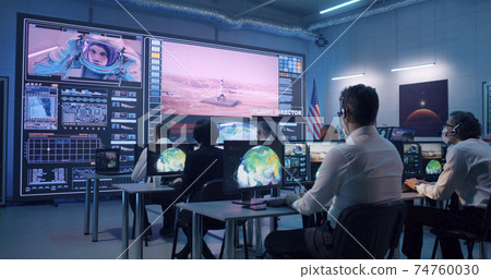 Team watching rocket launch in office 74760030