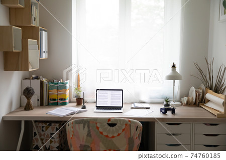 Empty desk with laptop and paperwork at home Empty desk with laptop and paperwork at home 74760185
