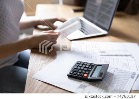 Close up of woman manage finances paying online 74760187