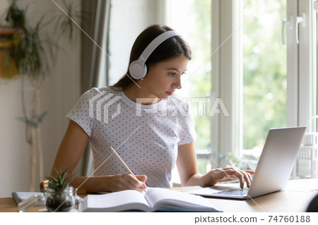 Millennial female student study online on laptop 74760188