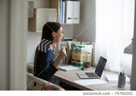 Overjoyed woman feel euphoric with good news on laptop 74760202