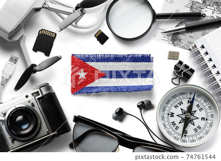 Flag of Cuba and travel accessories on a white background. Flag of Cuba and travel accessories on a white background. 74761544