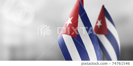 Small national flags of the Cuba on a light blurry background 74761546