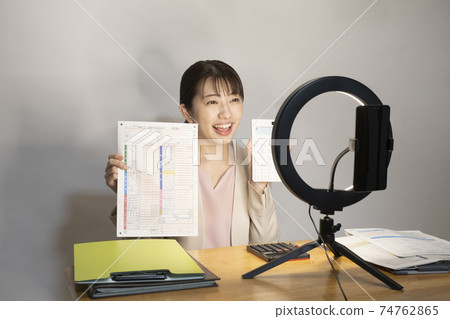 A woman explaining how to file a tax return on YouTube A woman explaining how to file a tax return on YouTube 74762865