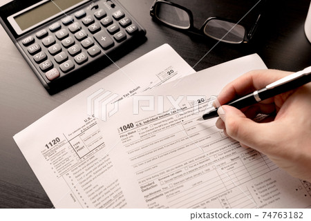 US tax form on desk. Tax income concept US tax form on desk. Tax income concept 74763182