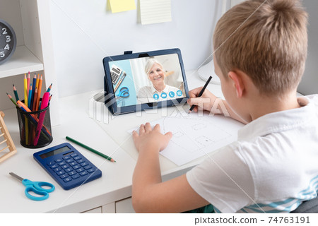 Remote learning concept with boy using tablet Remote learning concept with boy using tablet 74763191