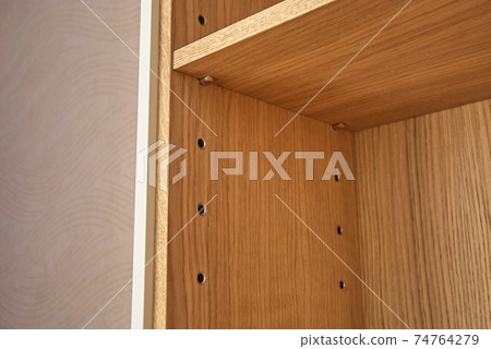 Stylish cupboard made with solid oak timber and veneer closeup 74764279