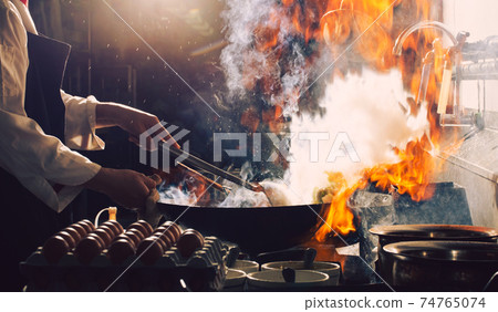 Chef is stirring food 74765074
