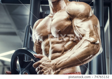 Bodybuilder athletic man workout muscles exercise Bodybuilder athletic man workout muscles exercise 74765132