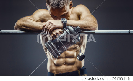 man drinking water after fitness workout 74765166