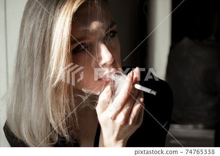 Young Woman Smoking Cigarette Young Woman Smoking Cigarette 74765338