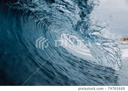 Perfect ocean waves with blue water cloudy sky. 74765688