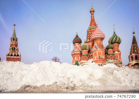 Snow pile near St. Basil's Cathedral and Spasskaya tower. Winter in Moscow, Russia. Snow pile near St. Basil's Cathedral and Spasskaya tower. Winter in Moscow, Russia. 74767290