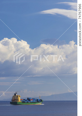 cargo ship nearby Capo Peloro Lighthouse in Punta del Faro on the Strait of Messina, most north eastern promontory of Sicily, Italy cargo ship nearby Capo Peloro Lighthouse in Punta del Faro on the Strait of Messina, most north eastern promontory of Sicily, Italy 74767966
