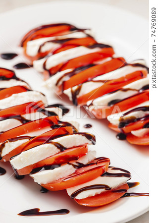 tomatoes with mozzarella and balsamic cream tomatoes with mozzarella and balsamic cream 74769089