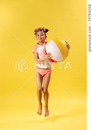 cute little child girl in swimsuit with beach ball cute little child girl in swimsuit with beach ball 74769208