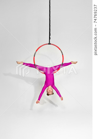 Girl gymnast shows an acrobatic performance Girl gymnast shows an acrobatic performance 74769237