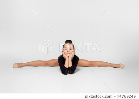 girl in black sportswear sitting on a transverse twine. girl in black sportswear sitting on a transverse twine. 74769249