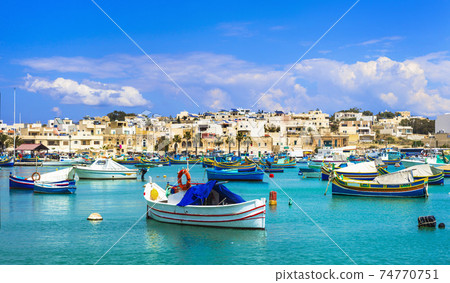 Marsaxlokk village with traditional colorful fishing boats Luzzu in Malta 74770751