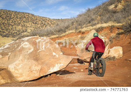 riding a fat bike on mountain desert trail 74771763