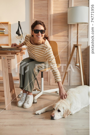 Smiling Blind Woman with Guide Dog at Home 74771956