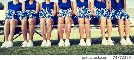 Cheerleading Squad Sitting on Bench Cheerleading Squad Sitting on Bench 74772259