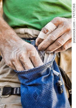 Photo of Climber Getting Chalk from Chalk Bag Photo of Climber Getting Chalk from Chalk Bag 74772368