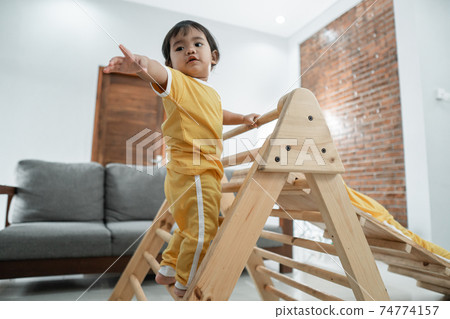 baby is afraid to reach out for help while climbing on the pikler triangle toy baby is afraid to reach out for help while climbing on the pikler triangle toy 74774157