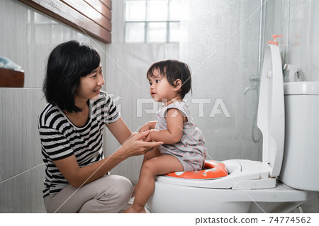 woman and baby poop with toilet background 74774562